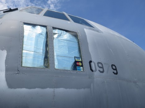 C-130 window with credit card stickers