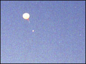 Photograph of Weather Balloon Climbing into the Sky