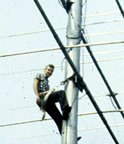 Jules Madey climbing a radio tower.