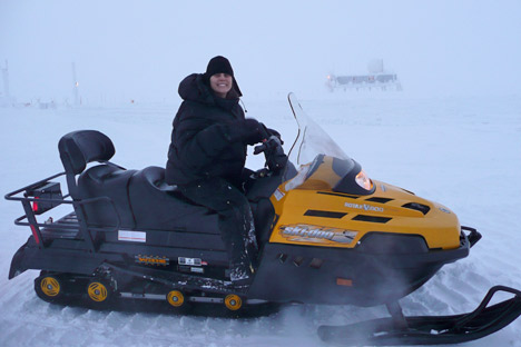 Photograph of Lora Koenig on a snowmobile, Greenland Summit, 2009.
