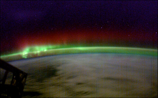 photograph of green aurora topped by red