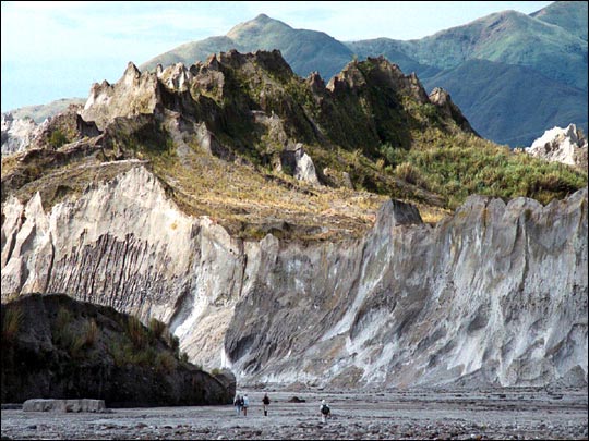 Scientists explore an eroded lahar
