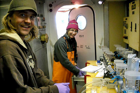 Photograph of scientists Mike Novak and Veronica Lance in a lab aboard the Delaware 2.