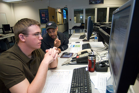 Photograph of flight control engineers brining Aqua back on line in the control room, NASA GSFC.