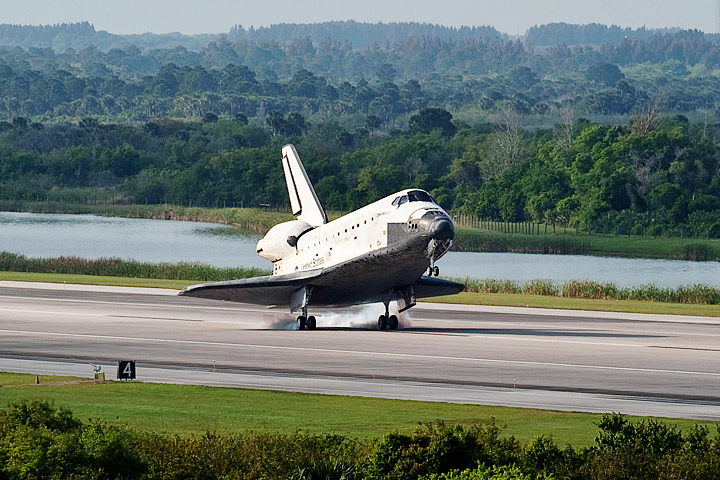 Smoke rises from Space Shuttle Discovery's tires as it lands at Kennedy Space Center.