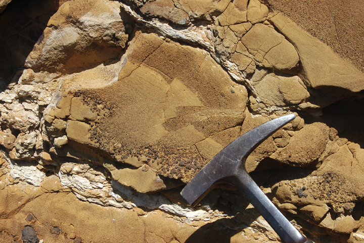 Photograph of Table Rock Tuff, Oregon, with hammer for scale.