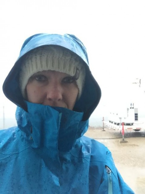 Dr. Angela Rowe (UW) heads out into the wind and rain to help launch another sounding.