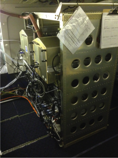 The AMP (aerosol microphysical processes) rack being integrated on the DC8. You can see there’s some work to be done neatening and tying down the cabling. The instruments on the top are two Nucleation Mode Aerosol Size Spectrometers (NMASSs), which measure aerosol size distributions between 3 and 60nm. Lower in the rack are two Ultra High Sensitivity Aerosol Spectrometers (UHSASs), which measure particles between 60 and 800nm, and a Laser Aerosol Spectrometer, getting the size distribution from 90nm up to 7.5μm. (Credit: Christina Williamson)