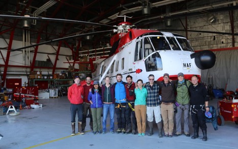 Team posing in front of the helicopter that will take us to our ice camp. From left to right we have: Johnny, Charlie, Rohi, Asa, Matt, Clem, Sarah, Larry, Sacha, Brandon and Lincoln. 