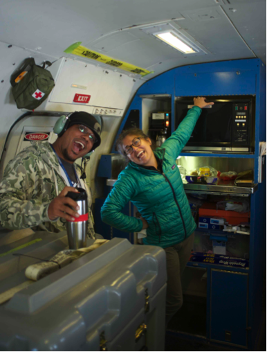 The mess in action: Matt Berry (Mission Director) and Stacy Hughes (Whole-air sampling princess), bringing life to the rear cabin. Stacy is testing a new application of the microwave: to warm her hands because the flight was brutally cold. I think she was heating a New Zealand meat pie as her meal. Credit: Joshua Schwarz