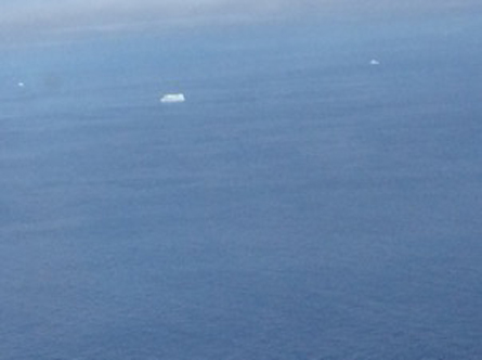 Lonely iceberg floating at off the eastern coast of Ellesmere Island, Canada. Satellite data show that areas around Ellesmere Island, that formerly retained floating ice all year round, are now ice free like the waters in this image.